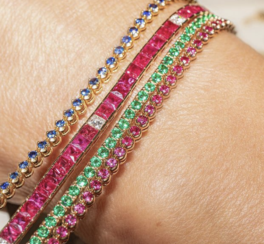 Stack of ruby, sapphire, emerald bracelets
